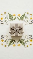 Elegant gift box with brown ribbon surrounded by yellow flowers, fern leaves and lavender stems arranged in symmetrical pattern on neutral background.