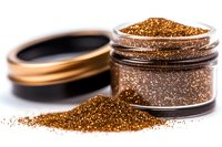Copper metallic glitter powder scattered from open cosmetic jar on white surface, macro shot showing sparkly texture and shimmer effect for makeup and crafts.