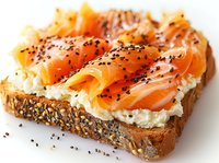Fresh smoked salmon and cream cheese on multigrain bread topped with black sesame seeds, close-up view of gourmet breakfast or appetizer sandwich.
