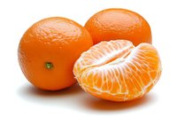 Fresh ripe mandarin oranges with one peeled showing juicy segments on white background, isolated citrus fruit for healthy eating and design elements.