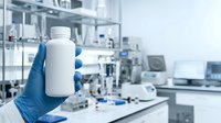 White pharmaceutical bottle held in gloved hand in laboratory setting with scientific equipment, suitable for healthcare, medicine, and pharmaceutical industry applications.