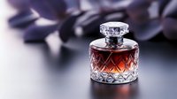Crystal glass perfume bottle with amber liquid on dark background with soft focus and purple petals. Luxury fragrance concept for cosmetic advertising.