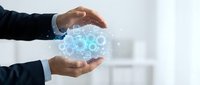Businessman hands protecting glowing digital gears and cogs symbolizing innovation, technology management, and business process optimization in modern office.