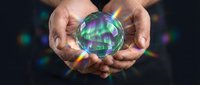 Hands holding glowing crystal ball with mystical aurora lights, fortune telling and spiritual guidance concept for meditation and divination practices.