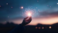 Magical glowing light particles floating above silhouetted hand reaching toward sunset sky with bokeh effects, creating mystical atmospheric scene at dusk.