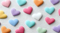 Colorful felt hearts scattered on white textured background. Handmade craft elements for Valentine's Day, love themes, DIY projects and romantic decorations.