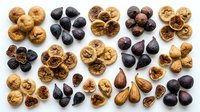 Dried figs in various stages of ripeness arranged on white background, showcasing golden and dark varieties for culinary, nutritional, and food styling applications.