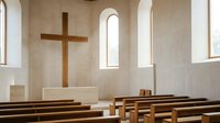 Wooden cross hanging on beige wall in modern church interior with empty wooden pews and arched windows, suitable for religious and spiritual design projects.