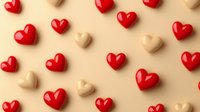Red and beige heart shapes scattered on cream background creating romantic pattern. Minimal love concept with glossy decorative elements for Valentine's day designs.