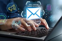 Professional hands typing on laptop with digital email marketing interface displaying newsletter campaign icons and subscription management graphics.
