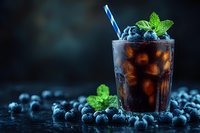 Refreshing cola drink with fresh blueberries and mint garnish in glass with striped straw against dark background, perfect for beverage advertising.
