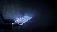 Businessman holding glowing digital circuit board with light rays emanating from device against dark background, representing technology innovation and digital transformation.