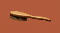 Wooden hair brush with natural bristles on terracotta background for grooming and styling routines.