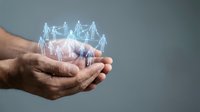 Male hands holding glowing network of connected people icons representing teamwork, collaboration, and social connections in business environment.