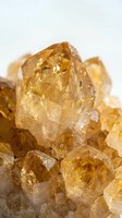 Golden citrine quartz crystal cluster with natural faceted formations and transparent amber gemstone minerals for healing and meditation practices.