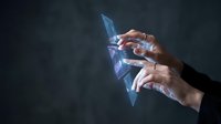 Businessman hands touching futuristic holographic interface with digital data visualization and glowing blue light effects on dark background.