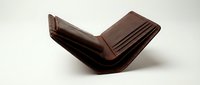 Open brown leather bifold wallet with card slots, isolated on white background, showcasing classic craftsmanship and elegant design.
