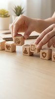 Hands arranging wooden blocks with healthcare symbols including brain, heart, meditation and medical cross on desk for wellness concept planning.