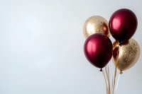 Elegant burgundy and gold metallic balloons on light background, festive party decoration for luxury events and celebrations. Copy space for text.