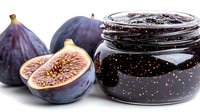 Fresh figs halved and whole with homemade jam in glass jar on white background, suitable for food packaging, recipes, and culinary content.