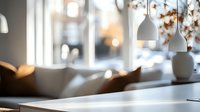 Sunlit modern interior with white pendant lamps and soft bokeh effect through windows. Minimalist home decor with natural light creating peaceful atmosphere.