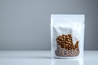 White resealable stand-up pouch with fresh roasted coffee beans visible through transparent window, photographed on light gray background for packaging design.