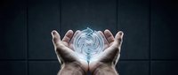 Hands holding glowing digital sphere with swirling blue data patterns against dark background, representing technology, innovation, and digital transformation for business concepts.