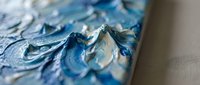 Thick blue oil paint strokes with impasto technique creating textured abstract art surface for creative projects and artistic backgrounds.