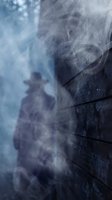 Heavy rain pouring down on dark brick wall with water streaming and splashing, creating atmospheric weather conditions for storm, climate, and nature concepts.