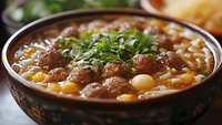 Hearty bean stew with herbs in rustic bowl, comfort food for restaurant menus and cooking blogs.