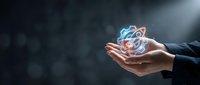 Businessman hands holding glowing atomic structure model with electrons orbiting nucleus representing science, physics education and molecular research concepts.