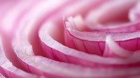 Delicate pink rose petals in extreme macro photography showing soft curves and layers with dreamy bokeh effect, creating romantic and feminine composition.