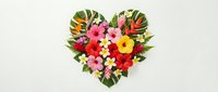Heart-shaped arrangement of vibrant tropical flowers and lush green leaves on white background, perfect for Valentine's Day, wedding, or summer celebration designs.