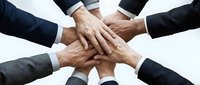 Business team hands stacked together showing unity, teamwork and collaboration in corporate environment for partnership success.