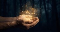 Male hands cupped together holding glowing golden light particles and sparkles against dark background for spiritual and magical concepts.
