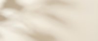 Soft beige fabric texture with gentle folds and wrinkles creating elegant drapery effect for luxury interior design and fashion backgrounds.