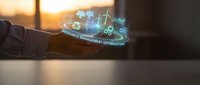 Businessman hand holding holographic display showing renewable energy icons and optimization data with sunset background for sustainable technology concepts.