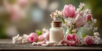 Spa wellness scene with pink tulips, cherry blossoms and natural skincare bottle on rustic wooden table for relaxation and beauty treatments.