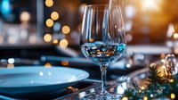 Empty wine glass on elegant dining table with warm bokeh lights and festive decorations creating luxurious holiday atmosphere for celebration events.
