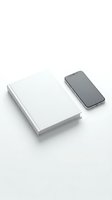 White blank book and smartphone mockup on clean background for branding and design projects.