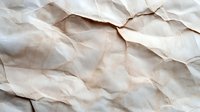 Crumpled beige paper with natural folds and wrinkles creating abstract textural pattern. Vintage grunge surface with shadows and creases for artistic backgrounds.