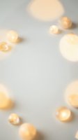 Soft blurred golden lights creating warm bokeh effect on neutral background for festive holiday decoration and ambient lighting design.