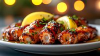 Grilled octopus tentacles glazed with savory sauce, garnished with fresh herbs and lemon slices on white plate. Soft bokeh lights create warm restaurant ambiance.