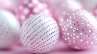 Pink and white Easter eggs with decorative patterns including dots and stripes arranged in soft focus composition for spring holiday celebrations.