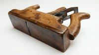 Vintage wooden hand plane tool for woodworking carpentry craftsmanship traditional crafts antique equipment isolated on white background ready for design.