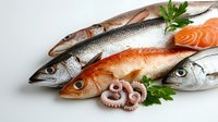 Fresh seafood selection with whole fish salmon fillets and octopus tentacles arranged on white background for culinary cooking and healthy nutrition concepts.