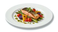 Grilled salmon fillet with colorful vegetables and herbs on white plate. Restaurant quality dish with cherry tomatoes, peppers and greens for culinary content.