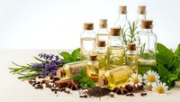 Natural essential oils in glass bottles with cork stoppers surrounded by fresh herbs, lavender, chamomile flowers and seeds for aromatherapy and wellness.