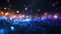 Magical glowing blue and orange bokeh lights on dark background with sparkle effect and defocused particles creating dreamy atmosphere.