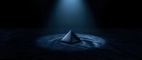 Metallic pyramid isolated on dark textured surface with dramatic spotlight illumination, suitable for corporate branding, tech concepts, and modern design projects.